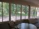 The sunroom features many windows providing lots of natural light and a view of the wooded yard at 14244 Sw 115Th Cir, Dunnellon, FL 34432
