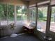 Sunroom with large windows providing serene views of the lush surroundings and natural light at 14244 Sw 115Th Cir, Dunnellon, FL 34432
