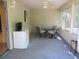 The sunroom has lots of windows, a table and chairs, and a small refrigerator at 14244 Sw 115Th Cir, Dunnellon, FL 34432