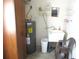 Laundry area with utility sink, storage cabinets, and water heater at 14244 Sw 115Th Cir, Dunnellon, FL 34432