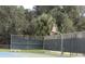 Community basketball court featuring a hoop, fencing, and a surrounding natural landscape at 18956 Sw 93Rd Loop, Dunnellon, FL 34432