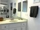 Bright bathroom vanity with white cabinets, framed mirrors, and decorative towels, creating a fresh aesthetic at 18956 Sw 93Rd Loop, Dunnellon, FL 34432
