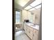 Bathroom featuring white cabinets and neutral marble countertops, and natural light at 18956 Sw 93Rd Loop, Dunnellon, FL 34432