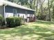 The home's exterior with lush landscaping and a well-maintained yard, creating a tranquil and inviting outdoor space at 18956 Sw 93Rd Loop, Dunnellon, FL 34432