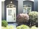 A stylish front door framed by meticulous landscaping and a modern aesthetic at 18956 Sw 93Rd Loop, Dunnellon, FL 34432
