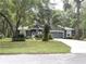 Charming single-story home featuring a manicured lawn and mature trees at 18956 Sw 93Rd Loop, Dunnellon, FL 34432
