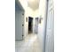 Hallway featuring white walls, white trim and doors, and neutral tile flooring at 18956 Sw 93Rd Loop, Dunnellon, FL 34432