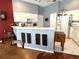 The spacious kitchen features white cabinetry, a breakfast bar, and access to the dining room at 18956 Sw 93Rd Loop, Dunnellon, FL 34432