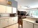 Open concept kitchen with white cabinets and modern appliances with access to the living area at 18956 Sw 93Rd Loop, Dunnellon, FL 34432