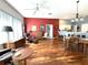 Open-concept living area features hardwood floors, natural light, and comfortable seating at 18956 Sw 93Rd Loop, Dunnellon, FL 34432