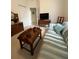 Comfortable living room featuring a striped couch and vintage wooden furniture at 18956 Sw 93Rd Loop, Dunnellon, FL 34432