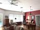 Inviting living room featuring hardwood floors, neutral paint, ceiling fans, and access to the backyard at 18956 Sw 93Rd Loop, Dunnellon, FL 34432