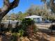 Community pool area enclosed by black fence and featuring lounge chairs and a clear, inviting pool at 18956 Sw 93Rd Loop, Dunnellon, FL 34432