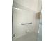 Minimalist shower featuring white tiled walls, providing a clean and open feel at 18956 Sw 93Rd Loop, Dunnellon, FL 34432