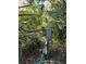 Outdoor utilities near the residence, surrounded by landscaping and featuring the gray electric box at 18956 Sw 93Rd Loop, Dunnellon, FL 34432