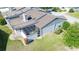 Aerial view of home showcasing a well-maintained exterior, screened patio, and lush green lawn at 1951 Se 37Th Court Cir, Ocala, FL 34471