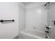 Bright bathroom featuring a tub with white tiled walls and bronze fixtures, creating a clean and modern aesthetic at 1951 Se 37Th Court Cir, Ocala, FL 34471