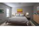 Inviting bedroom featuring a cozy bed, soft lighting, and natural light from the window at 1951 Se 37Th Court Cir, Ocala, FL 34471