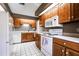 Traditional kitchen featuring white appliances, white countertops, and wooden cabinetry at 1951 Se 37Th Court Cir, Ocala, FL 34471