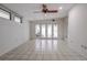 Open living area with tiled flooring and glass doors leading to a backyard at 1951 Se 37Th Court Cir, Ocala, FL 34471