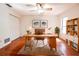 Well-lit home office featuring a wooden desk, hardwood floors, and built-in shelving at 1951 Se 37Th Court Cir, Ocala, FL 34471
