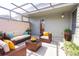 Cozy enclosed patio featuring a comfortable lounge area with stylish furnishings and natural greenery at 1951 Se 37Th Court Cir, Ocala, FL 34471