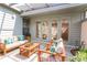 Relaxing screened patio with comfortable seating and natural light, perfect for outdoor enjoyment and entertaining guests at 1951 Se 37Th Court Cir, Ocala, FL 34471