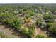 Aerial view of the property nestled among dense trees, showcasing its peaceful and private setting at 19939 Sw 96Th Pl, Dunnellon, FL 34432