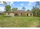 Lovely backyard showcasing the home's exterior with a covered patio ideal for outdoor enjoyment at 19939 Sw 96Th Pl, Dunnellon, FL 34432