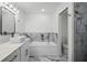 A luxurious bathroom with soaking tub, white marble accents, vessel sink and glass-enclosed shower at 19939 Sw 96Th Pl, Dunnellon, FL 34432