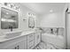 Bright bathroom with double sinks, marble accents, and modern bathtub at 19939 Sw 96Th Pl, Dunnellon, FL 34432