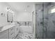 A luxurious bathroom with marble floors, marble shower and white dual sink vanity at 19939 Sw 96Th Pl, Dunnellon, FL 34432