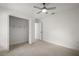 Bedroom featuring tile flooring, ceiling fan, and closet at 19939 Sw 96Th Pl, Dunnellon, FL 34432