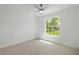 A bright bedroom with a ceiling fan and arched window letting in natural light at 19939 Sw 96Th Pl, Dunnellon, FL 34432