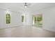 A bright main bedroom with lots of natural light, tile flooring and a ceiling fan at 19939 Sw 96Th Pl, Dunnellon, FL 34432