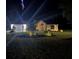 Well-lit front exterior with a manicured lawn, showcasing a charming entrance and attached garage at 19939 Sw 96Th Pl, Dunnellon, FL 34432