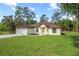 Charming single-story home features a well-manicured lawn and a classic design with a two car garage at 19939 Sw 96Th Pl, Dunnellon, FL 34432