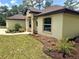 Single-story home with manicured landscaping and a covered front entry at 19939 Sw 96Th Pl, Dunnellon, FL 34432