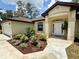 Charming single-story home featuring a well-manicured lawn, fresh landscaping, and an attached two-car garage at 19939 Sw 96Th Pl, Dunnellon, FL 34432