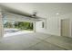 Clean garage interior featuring an open door with view of neighborhood street at 19939 Sw 96Th Pl, Dunnellon, FL 34432