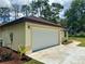 Spacious two car garage with a large driveway and manicured landscaping at 19939 Sw 96Th Pl, Dunnellon, FL 34432