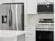 Modern kitchen features stainless steel appliances, white cabinets, and light countertops at 19939 Sw 96Th Pl, Dunnellon, FL 34432
