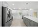 Bright kitchen with white cabinets, stainless steel appliances, and a large center island at 19939 Sw 96Th Pl, Dunnellon, FL 34432
