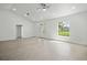 Bright living room with tiled floors, recessed lighting and an arched window with views to the front yard at 19939 Sw 96Th Pl, Dunnellon, FL 34432