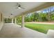 Covered patio with tiled floors, ceiling fans, and views of the lush green backyard, perfect for outdoor relaxation at 19939 Sw 96Th Pl, Dunnellon, FL 34432