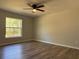 Comfortable bedroom featuring luxury vinyl plank flooring, a window with natural light, and neutral paint colors at 20652 Sw Cardinal Ave, Dunnellon, FL 34431