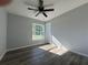 Bright bedroom features luxury vinyl plank flooring, a ceiling fan, and a window with ample natural light at 20652 Sw Cardinal Ave, Dunnellon, FL 34431