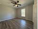 Bedroom with luxury vinyl plank flooring, ceiling fan, natural light, and fresh neutral paint colors at 20652 Sw Cardinal Ave, Dunnellon, FL 34431