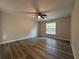 Comfortable bedroom with a ceiling fan and a window providing natural light and a view of the outdoors at 20652 Sw Cardinal Ave, Dunnellon, FL 34431