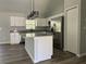 Modern kitchen featuring white cabinets, stainless steel appliances, granite countertops, and a functional island at 20652 Sw Cardinal Ave, Dunnellon, FL 34431